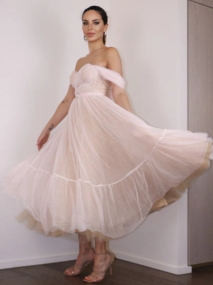 Back view of an A-line ruched off-shoulder prom dress.