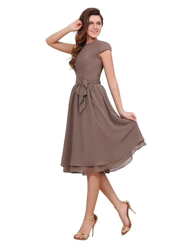 Full view of an A-line mother of the bride dress with jewel neck, short sleeves, and button details.