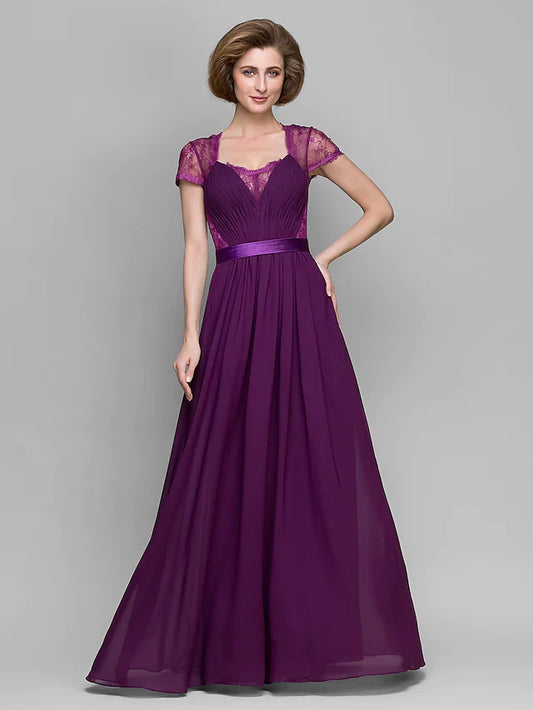 Woman wearing an A-Line mother of the bride dress with a square neck and short sleeves.