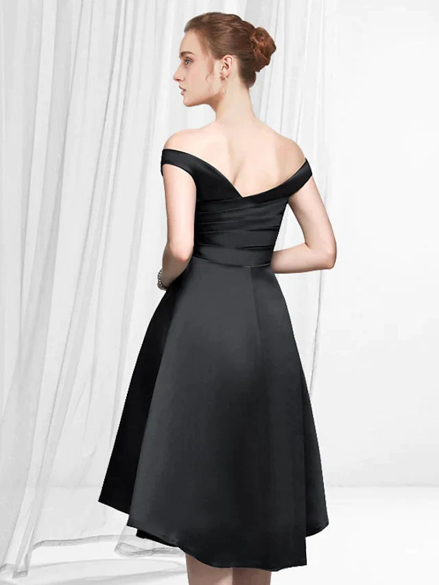 Side view of a woman in a sleek A-line off-shoulder satin cocktail dress.