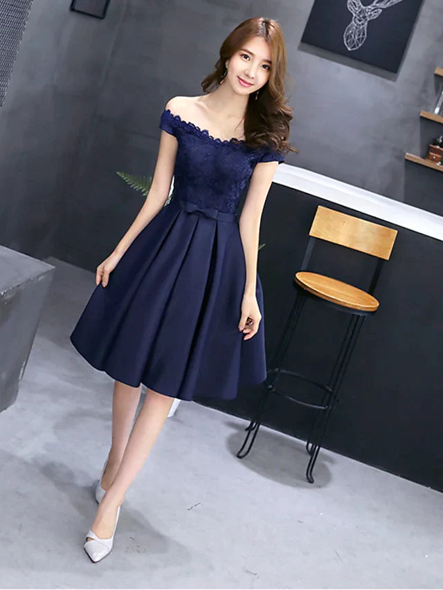 Side view of the model in the elegant floral lace off-shoulder mini dress.