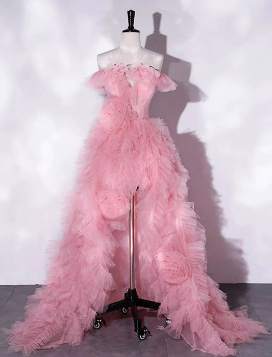 Model wearing an A-line off-shoulder floral tulle prom dress with a high slit.