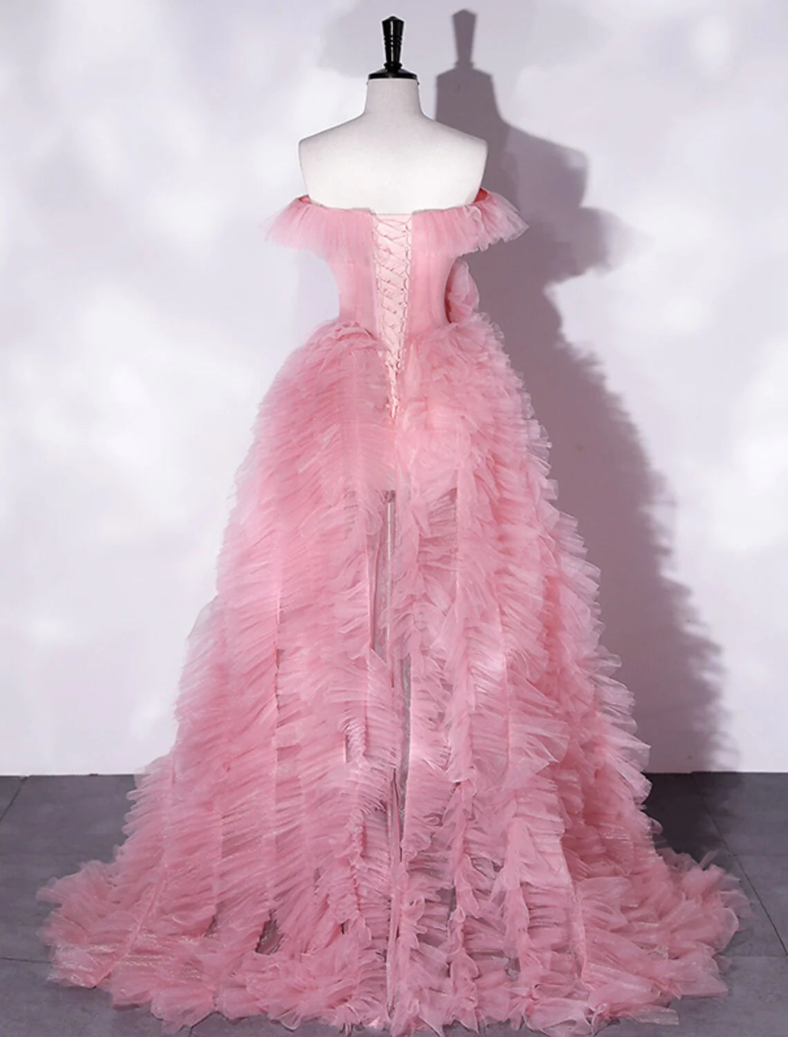 Back view of an A-line off-shoulder floral tulle dress, showing the flowing skirt.