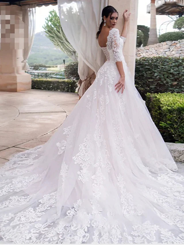 Back view of an A-line off-shoulder lace wedding dress, highlighting illusion sleeves and train.