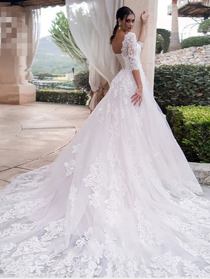 Back view of an A-line off-shoulder lace wedding dress, highlighting illusion sleeves and train.