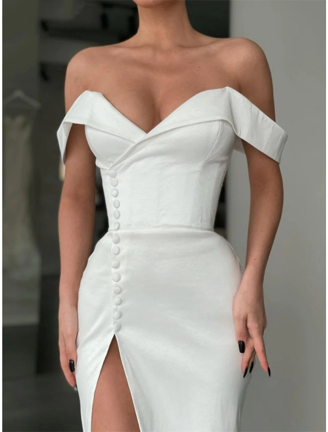 Side view of the A-line off-shoulder satin gown, showcasing the flowing court train.