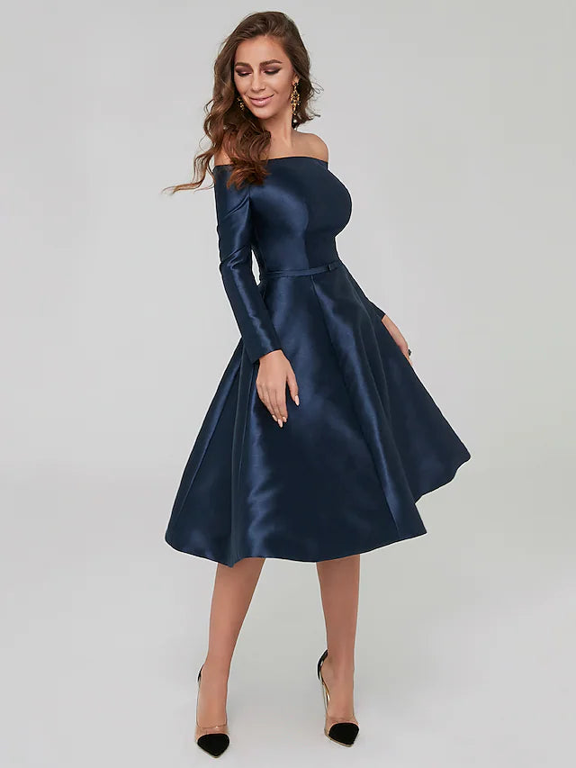 Woman posing gracefully in the knee-length special occasion dress, showcasing its elegant design.