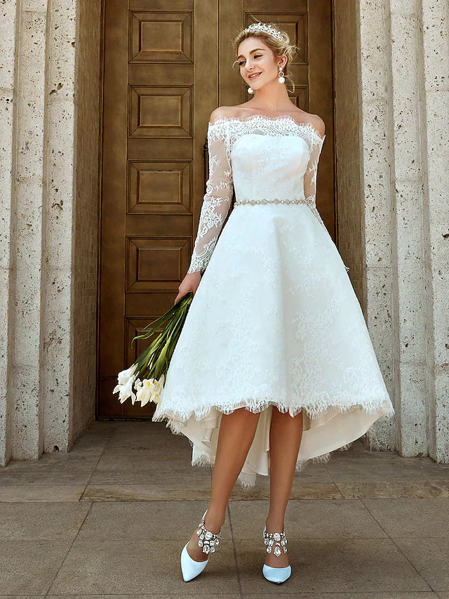 Side view of the A-line wedding dress, highlighting the silhouette and asymmetrical lace.