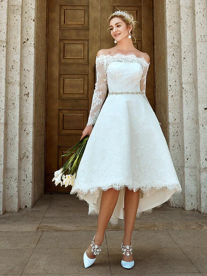 Side view of the A-line wedding dress, highlighting the silhouette and asymmetrical lace.