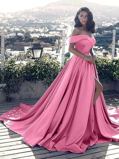 Back view of a model in a red A-line off-shoulder satin dress, highlighting the chapel train.