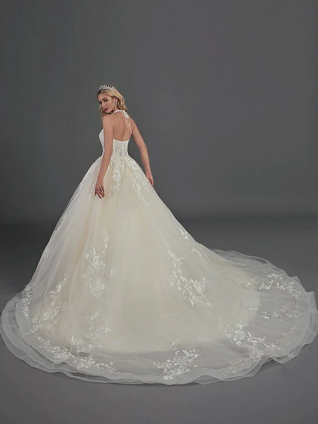 Back view of a bride in an A-line off-shoulder satin wedding dress with a court train and ruffles.
