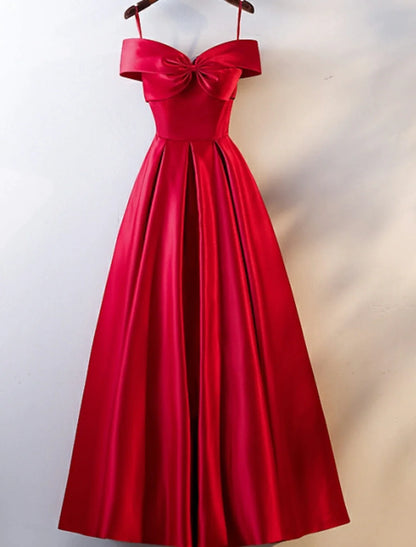 Model wearing a floor-length A-line off-shoulder satin prom dress with an open back.