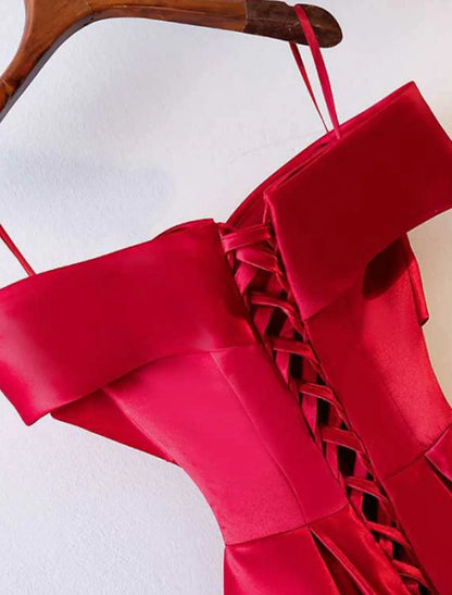 Close-up of the ruched satin fabric and off-shoulder neckline of the formal dress.