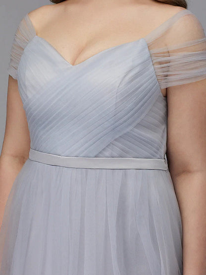 Close-up of the back of the light-colored tulle dress, highlighting the criss-cross detail.