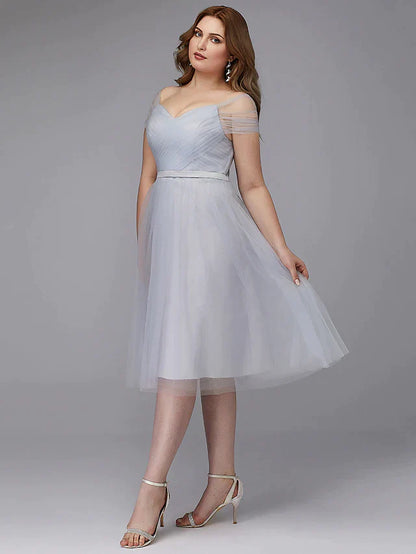Model in the light-colored A-line dress, showcasing the short sleeves and off-shoulder neckline.
