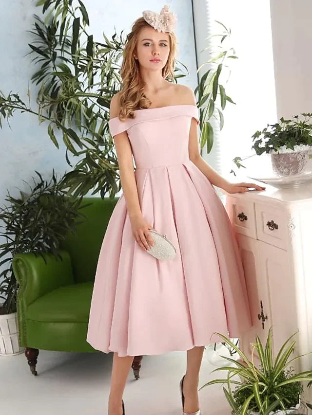 Woman in an elegant A-line off-shoulder tea-length cocktail dress.