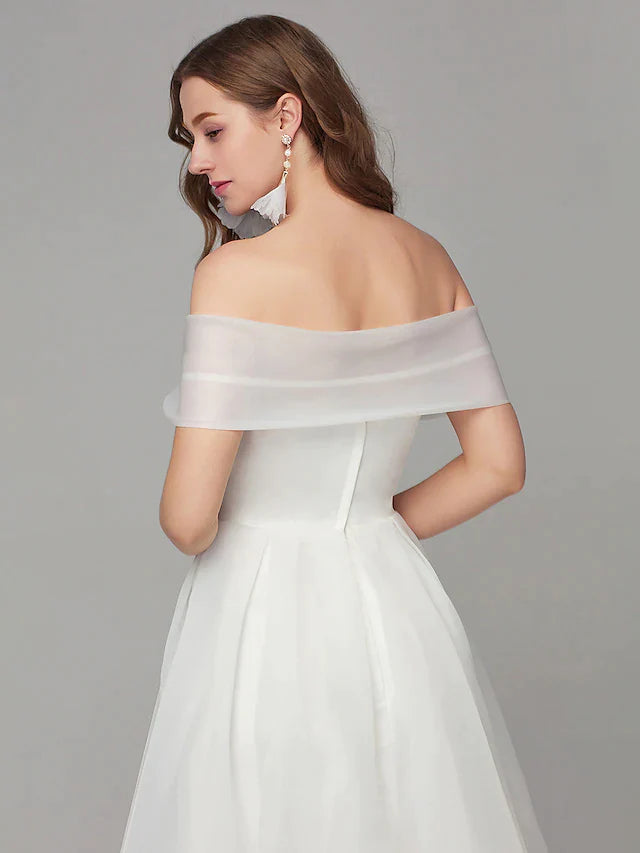 Full view of the white A-line organza tea-length dress, showcasing its elegant silhouette.
