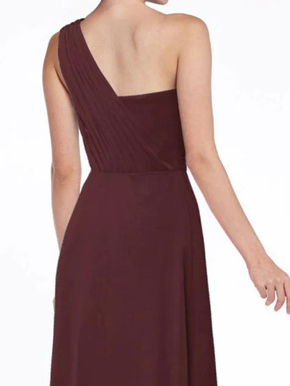 Close-up of the one-shoulder neckline and ruched bodice detail on the bridesmaid dress.