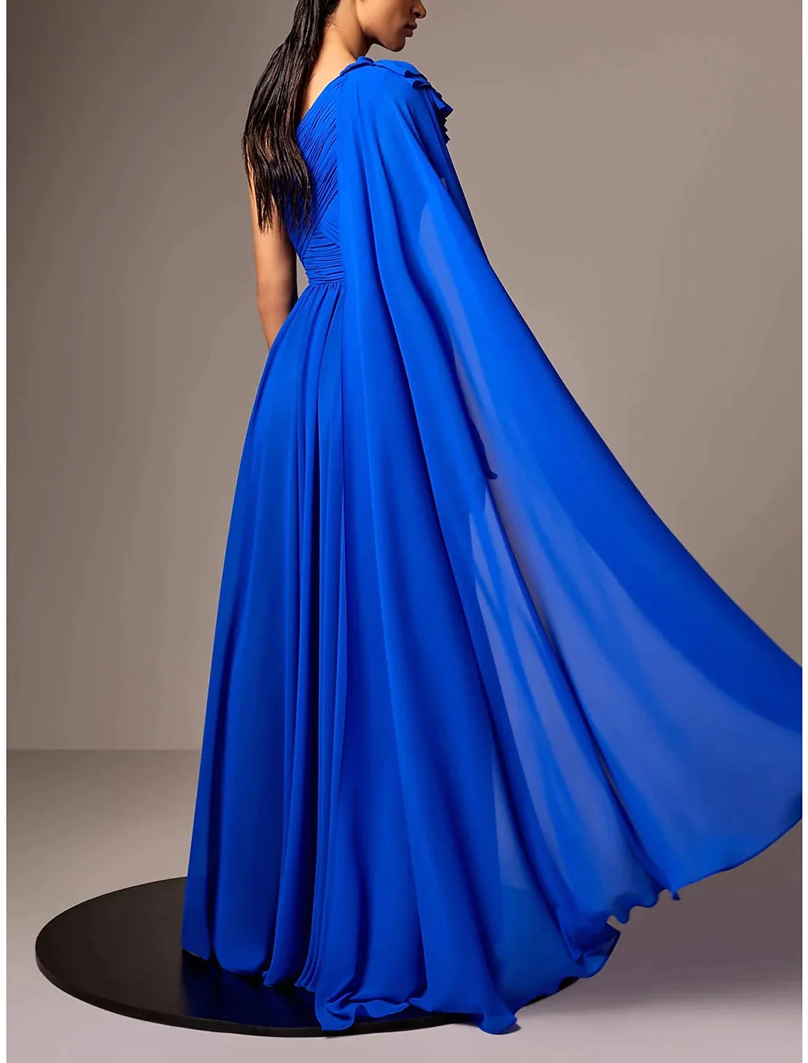 Close-up of the one-shoulder detail and ruched flower on the elegant chiffon gown.