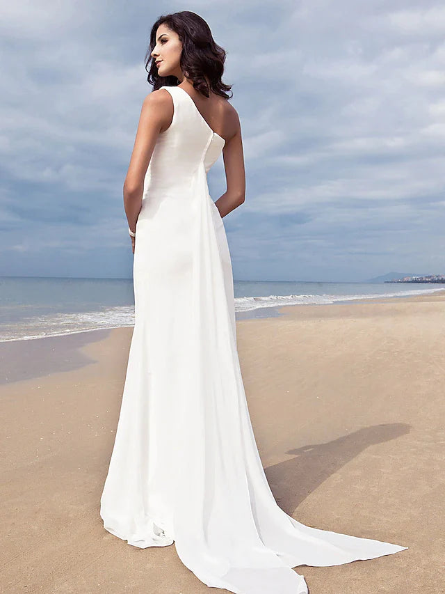 Close-up of the one-shoulder detail and flowing chiffon fabric of the wedding dress.