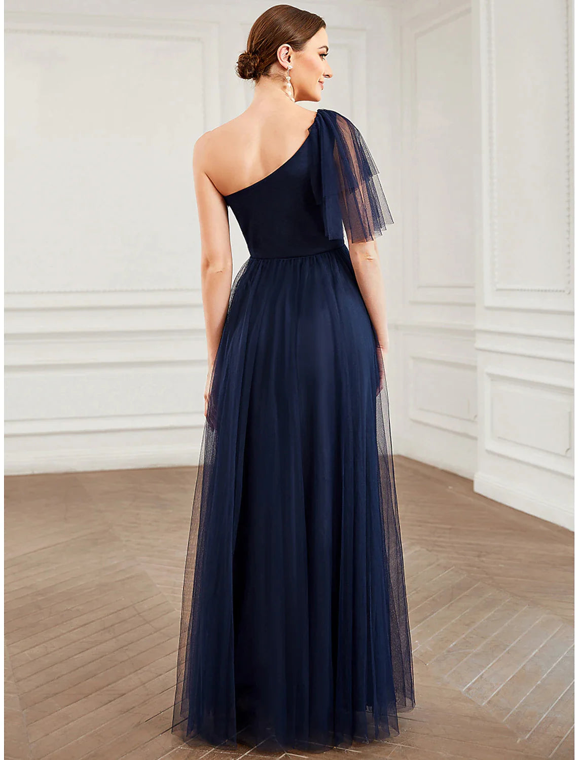 Side view of the light blue A-line one-shoulder tulle gown, showcasing the flowing skirt.