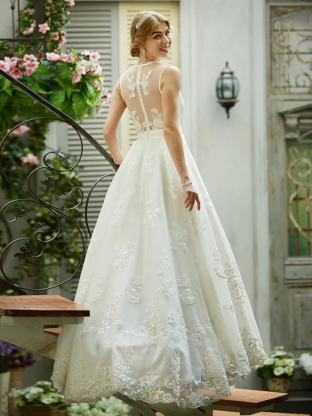 Close-up of delicate lace and tulle fabric on a wedding gown.
