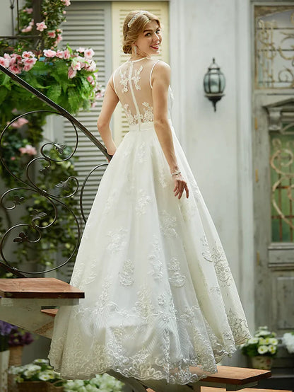 Close-up of delicate lace and tulle fabric on a wedding gown.