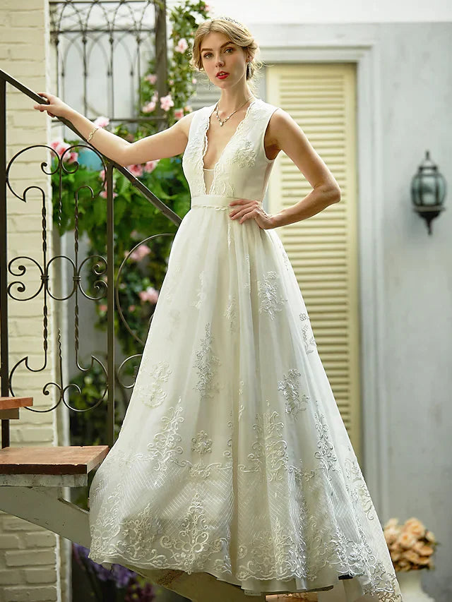 Back view of A-line wedding dress featuring illusion detail and sash.