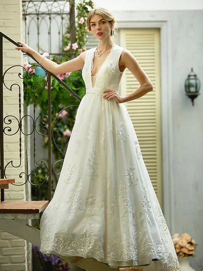 Back view of A-line wedding dress featuring illusion detail and sash.