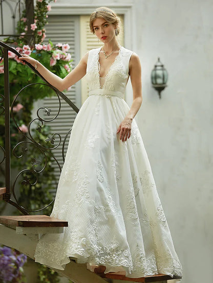 Full length view of a bride wearing a sleeveless A-line wedding dress.