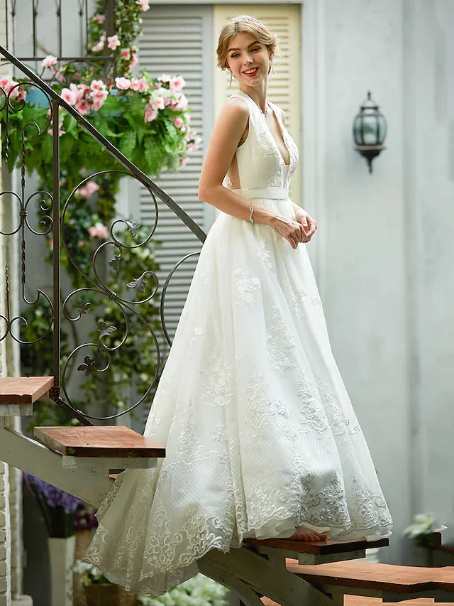 Side profile of an A-line wedding dress with a flowing tulle skirt.