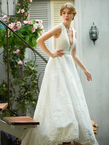 Bride posing gracefully in a romantic A-line bridal gown.