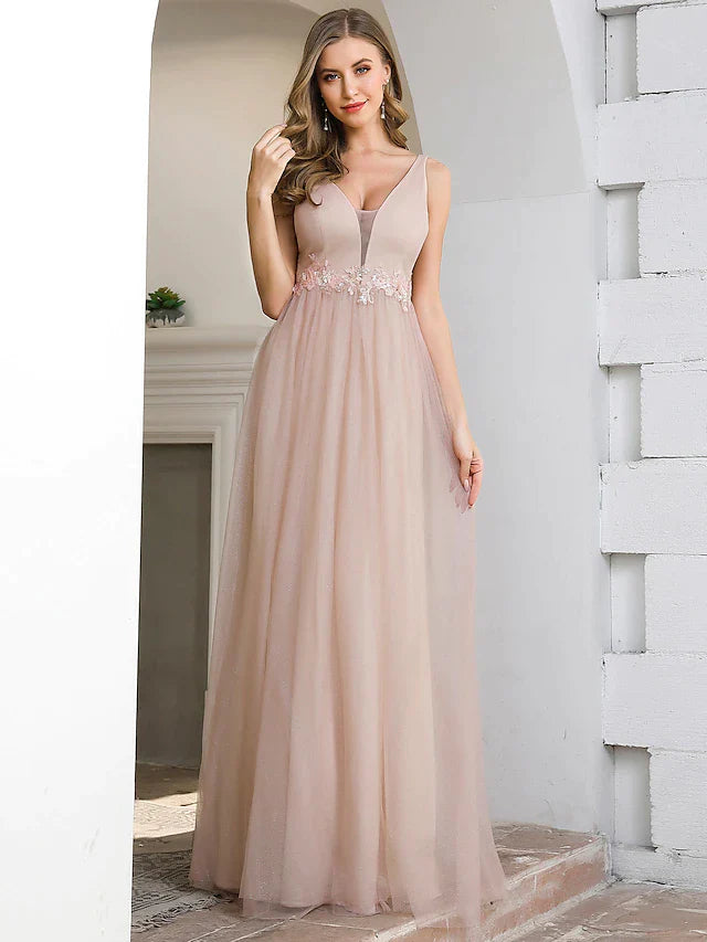 Back view of a woman in an A-line plunging neck tulle bridesmaid dress with appliques.