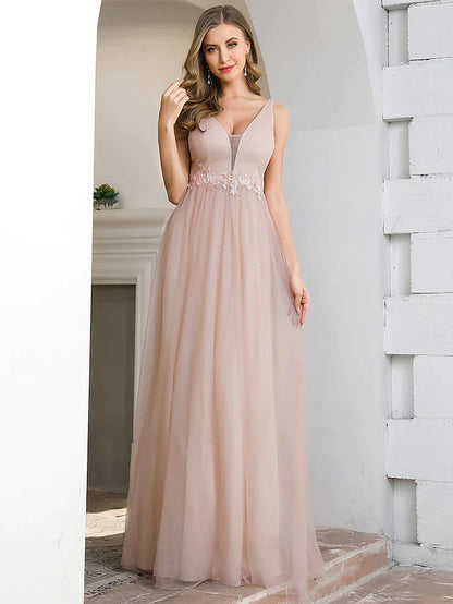 Back view of a woman in an A-line plunging neck tulle bridesmaid dress with appliques.