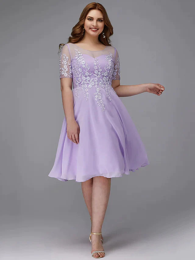 Plus size woman in an elegant A-line illusion neck short sleeve cocktail dress.