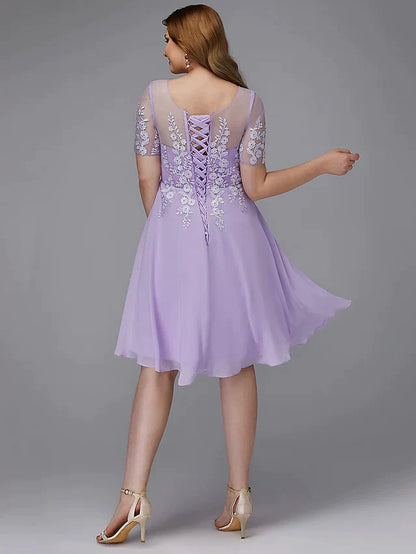 Back view of a plus size A-line knee-length dress with lace appliques.