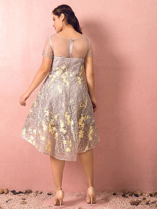 Back view of plus size A-line dress showing asymmetrical hem and lace.