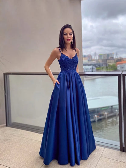 Elegant A-line princess prom dress with spaghetti straps and applique details.