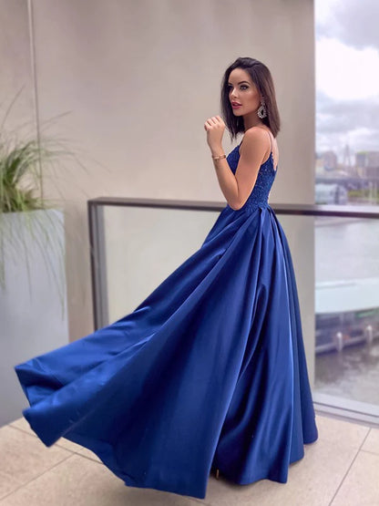 Side view of a luxurious satin floor-length prom dress with an A-line silhouette.