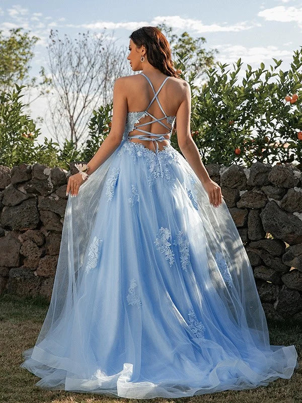 Back view of a model in a beautiful A-Line tulle prom dress with halter neckline.