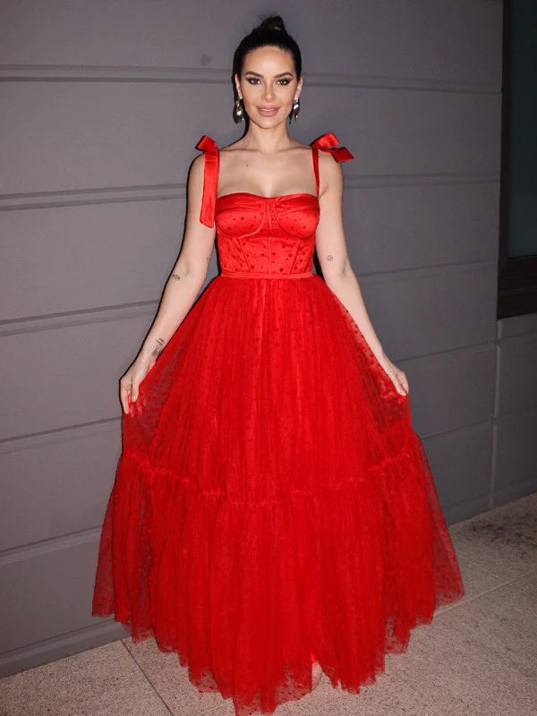 Full-length view of a woman wearing an elegant red A-line prom dress with square neck.