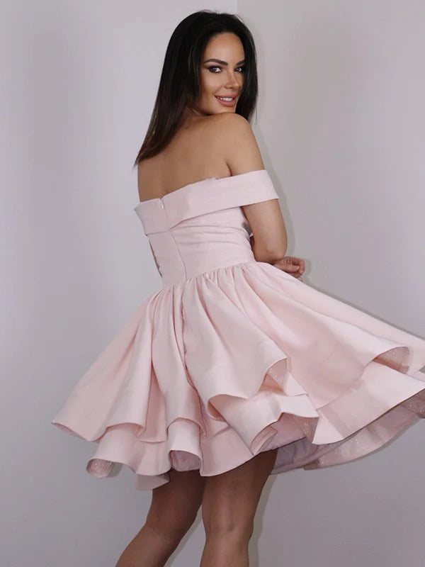 Side view of a woman in an A-line princess off-shoulder mini dress, showcasing the ruffles.