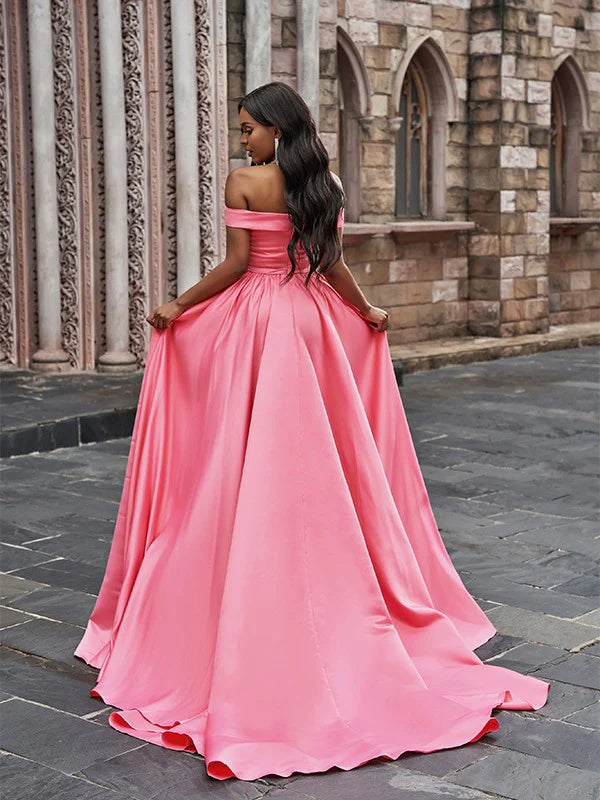 Side view of A-Line satin prom dress showing court train and ruffled neckline.