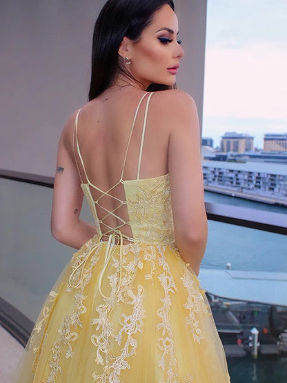 Back view of the A-line princess tulle floor-length dress with delicate spaghetti straps.