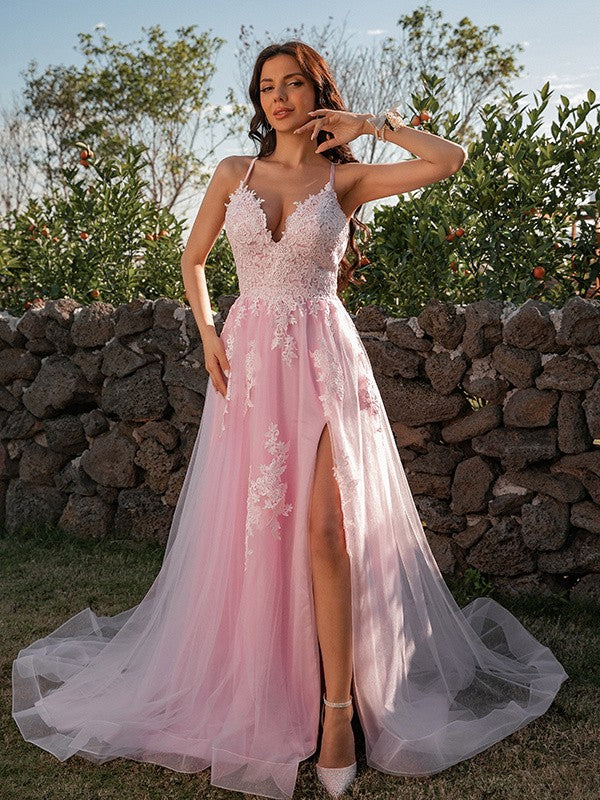 Close-up of the V-neckline and intricate applique details on the pink prom dress.