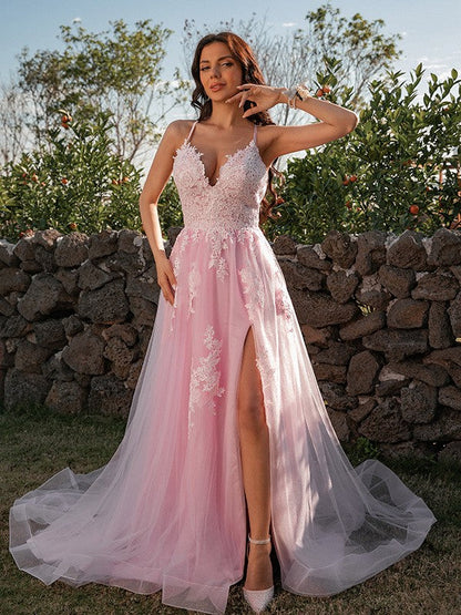 Close-up of the V-neckline and intricate applique details on the pink prom dress.