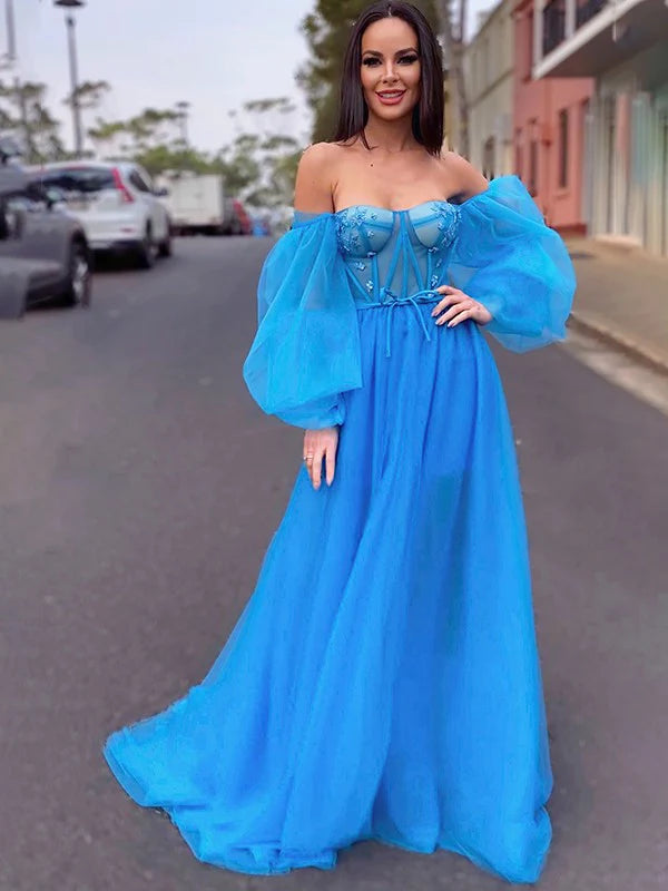 Model wearing an A-line princess tulle off-the-shoulder long sleeve dress, front view.