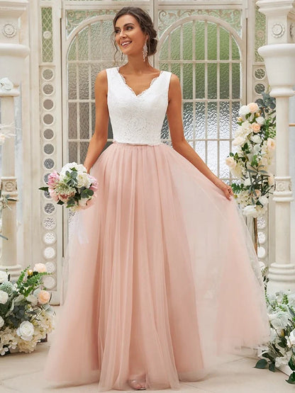 Front view of a woman in a sleeveless A-line lace bridesmaid dress.