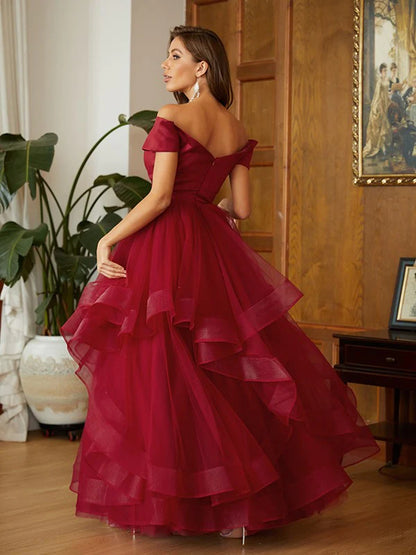 Front view of the A-line princess off-shoulder prom dress, highlighting the tulle fabric and ruffles.