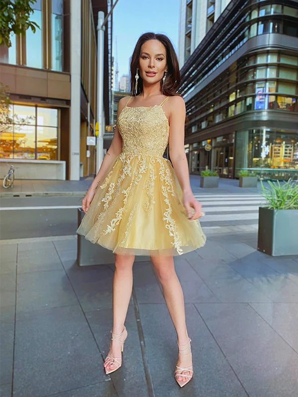 Front view of an A-line princess tulle homecoming dress with spaghetti straps and applique.